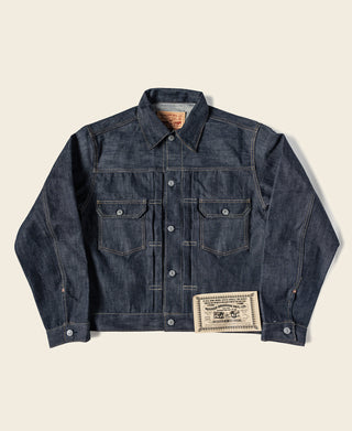 Indigo selvedge denim jacket front view with two chest pockets and stitched label patch