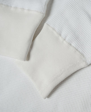 White waffle-knit cotton underwear with ribbed waistband and leg seam close-up