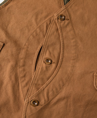 Canvas vest button placket with drawstring-style detail and pocket seams
