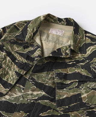 Camo fatigue jacket with stand collar, button front, and chest flap pockets.