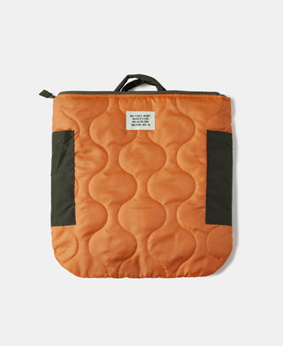 Olive nylon helmet bag with orange quilted interior lining and top handle