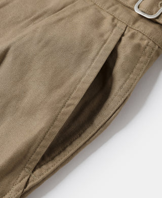 Khaki bermuda pants showing front seam details and pocket opening