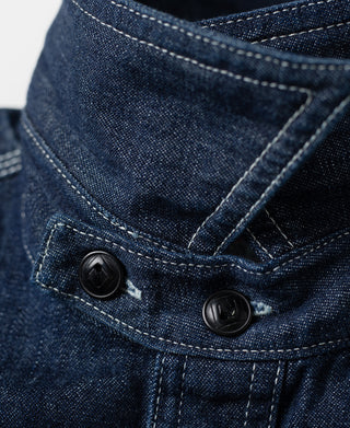Indigo denim chest pocket flap with snap buttons and contrast-stitched trim