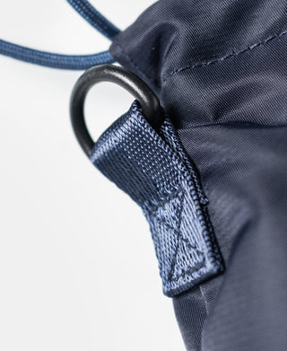 Navy drawstring tie with reinforced stitching and metal grommet