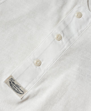 White henley T-shirt front placket with three buttons and logo patch