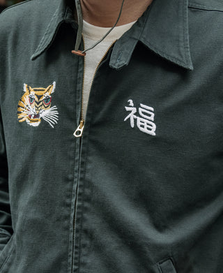 Dark green jacket front with zip placket, embroidered tiger logo, and white character print