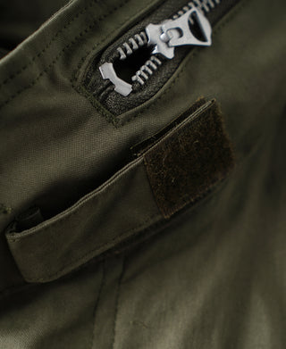 Olive parka sleeve placket and front pocket with flap; zipper and fabric texture
