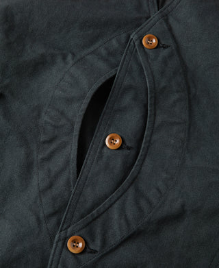 Dark green canvas vest front with overlapping placket and three round brown buttons