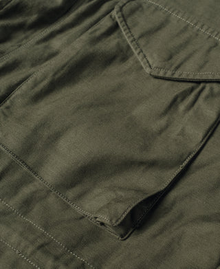 Olive field jacket chest pocket and stitched seams with button flap