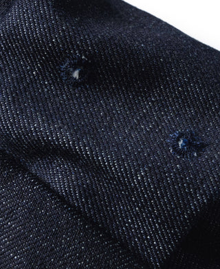 Indigo denim cap crown with woven texture and small distressed spots