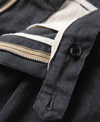 Dark gray chino trousers with coin pocket and front fly button closure