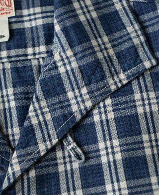 Blue plaid shirt jacket fabric with stitched seam and folded underarm detail