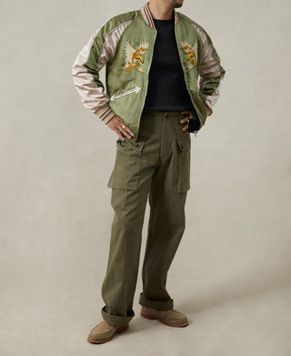 Reversible souvenir jacket with green front, bird embroidery on chest, ribbed collar and cuffs