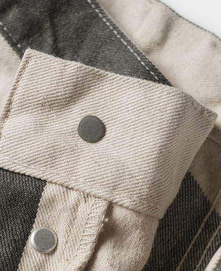 Wide striped prisoner pants pocket flaps in white with dark gray stripes and round snaps