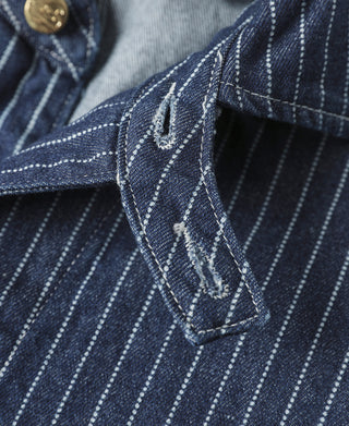 Indigo pinstripe work coat sleeve and embroidered chest pocket with brass snaps