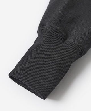 Black sweatshirt sleeve with ribbed cuff, close-up.