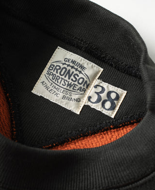 Two-tone sweatshirt collar label, black ribbed neckline with orange trim