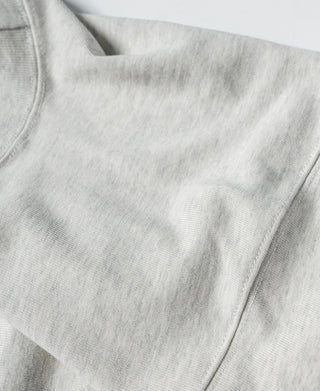 Light gray T-shirt sleeve and side seam close-up