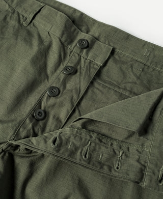 Olive fatigue pants waistband with four-button closure and cargo pocket panels