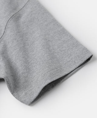 Gray cotton tubular T-shirt sleeve hem close-up, folded cuff edge detail.