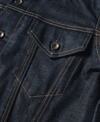 Indigo denim jacket chest flap with brass-look button and stitched seams