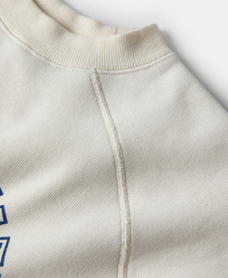 White raglan sweatshirt shoulder seam with ribbed crew neck