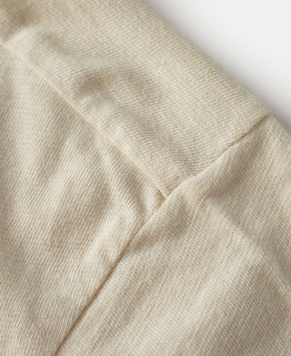 Cream T-shirt side seam and hem stitching close-up