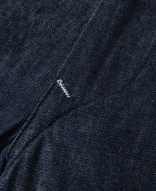 Indigo denim fabric with close-up seam and stitch detail