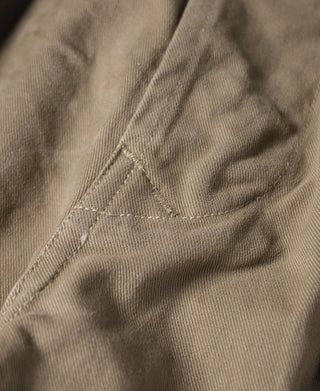 Khaki bermuda shorts stitched seam detail on fabric with reinforced stitching