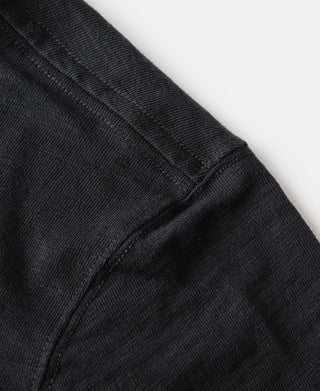 Black cotton T-shirt shoulder and side seam close-up