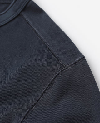 Navy long-sleeve henley shirt sleeve with ribbed cuff and stitched seam.