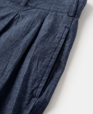 Indigo chambray pants with angled front slit and pleated front panel