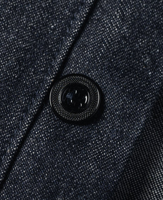 Close-up of dark navy denim button with circular metal shank