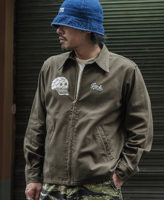 Olive souvenir jacket with white skull and “Jack” script embroidery on the chest