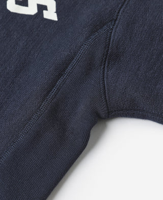Navy sweatshirt seam detail with knit rib stitching and shoulder-to-cuff panel