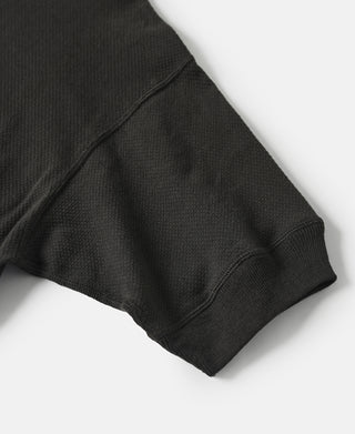 Black waffle-knit t-shirt hem with ribbed cuff at sleeve