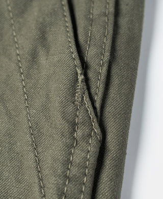 Olive utility shorts close-up of front seam and inner pleat construction