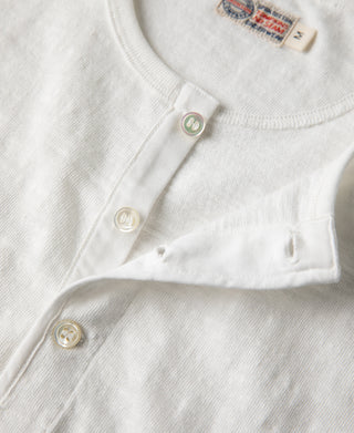 White henley t-shirt close-up of button placket and metal snap buttons