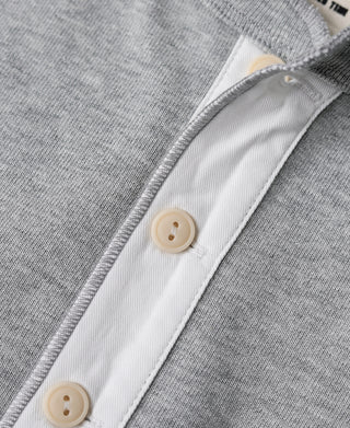 Gray henley shirt placket with beige button closures and contrast trim
