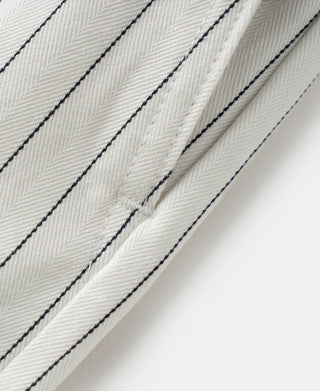White pinstripe fabric detail with dark blue vertical seam stitching