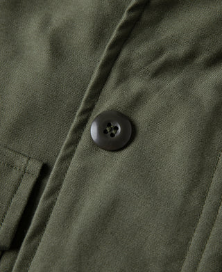 Olive field jacket shoulder with round button closure and stitched seam
