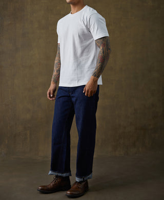 White cotton tubular T-shirt worn on male model, side profile