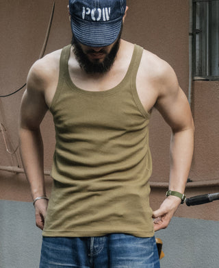 Olive sleeveless tank top on model; crew neckline and straight hem