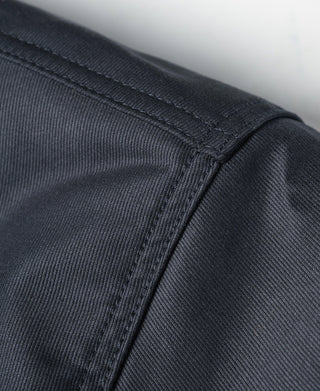 Navy deck jacket side panel close-up with stitched panel seam
