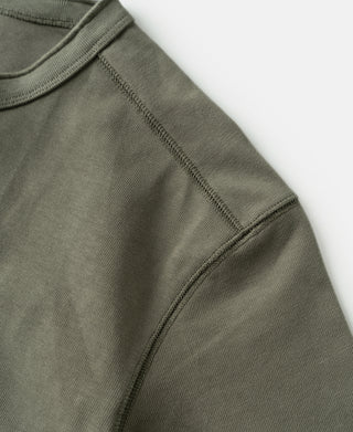 Light olive henley sleeve with ribbed cuff and visible side seam stitching