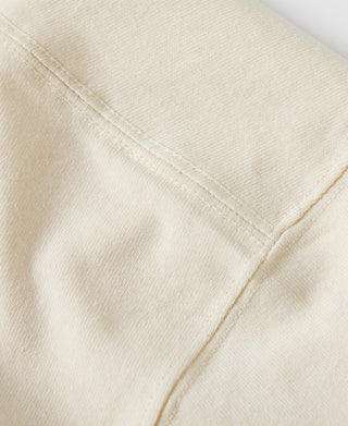 Off-white cotton T-shirt sleeve seam and hem close-up