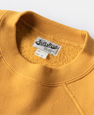 Yellow raglan sweatshirt neckline close-up with interior size label