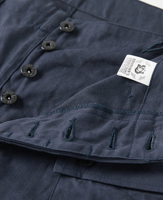 Navy utility shorts inner hem close-up with label and stitched snap closure
