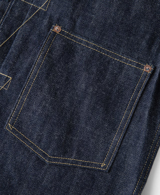 Indigo denim pocket panel with copper buttons and yellow contrast stitching
