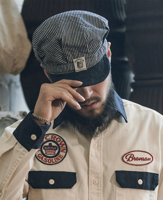 Railroad engineer cap on model, striped crown and dark denim brim with stitched detail